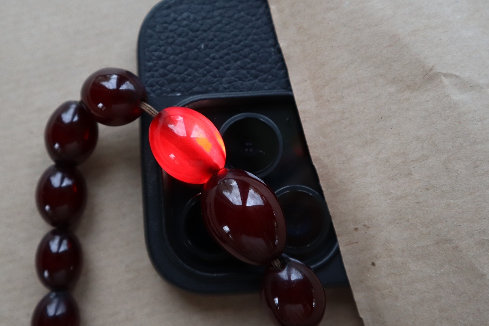 A Cherry amber / bakelite bead necklaces, with oval beads ranging in size from, 23mm to 8mm, - Image 6 of 14