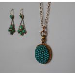 A yellow metal pendant of oval form set with turquoise on a 9ct yellow gold chain,