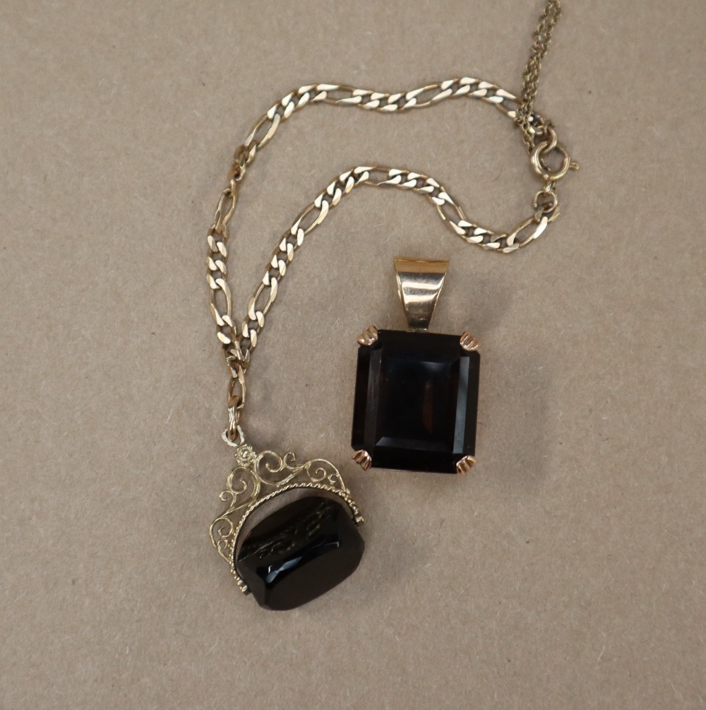 A smokey quartz pendant, set in yellow metal,