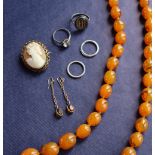 A simulated amber beaded necklace together with a pair of earrings, a cameo brooch,