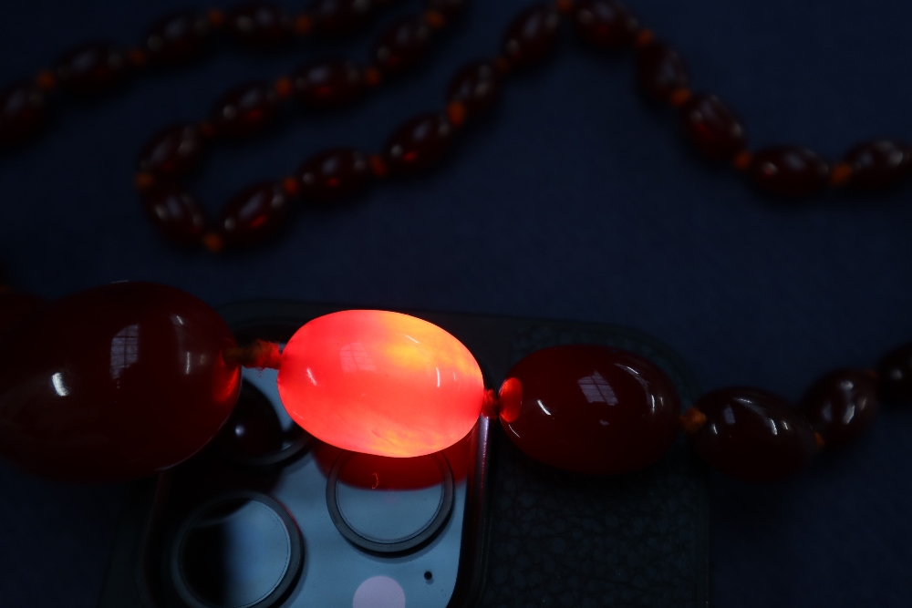 A cherry amber / bakelite beaded necklace, with graduating beads varying in size from 30mm to 10mm, - Image 4 of 9