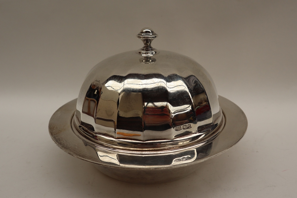 A George V silver muffin dish, liner and cover with a domed panelled cover and turned finial,
