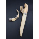 A walrus ivory dagger, the handle in the form of a walrus,