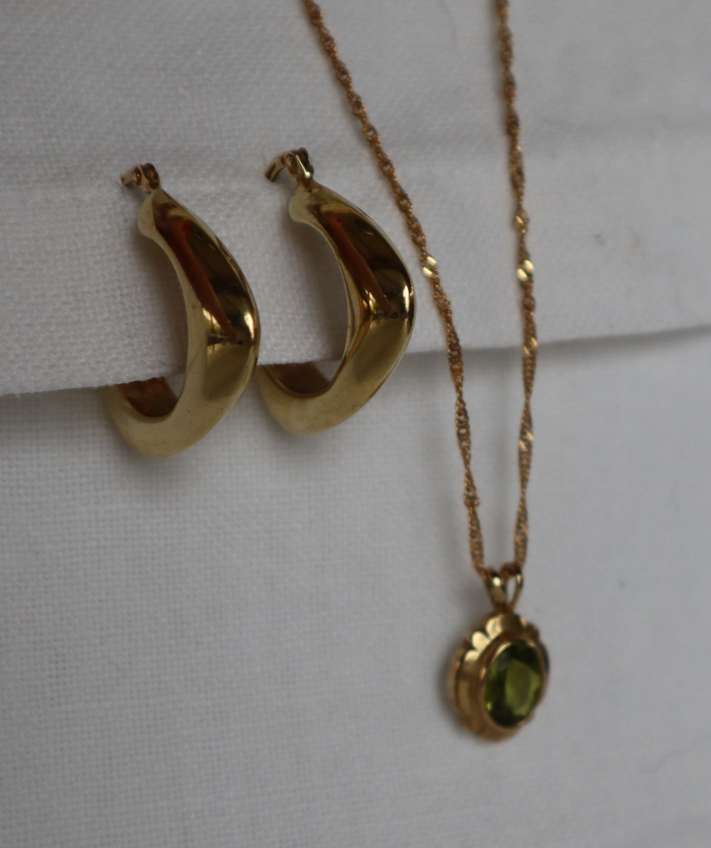 A pair of 9ct gold hoop earrings together with a 9ct gold peridot set pendant on a 9ct gold chain, - Image 2 of 4