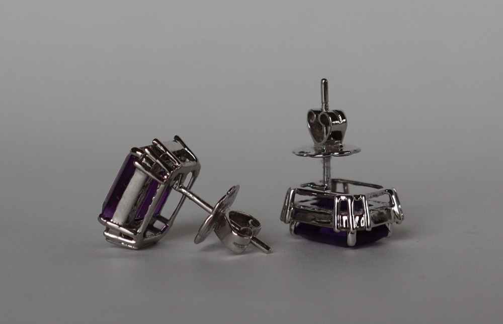 A pair of amethyst and diamond earrings each set with a step cut amethyst surrounded by twenty two - Image 2 of 6