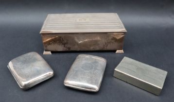 A George V silver cigarette box of rectangular form with line decoration and initials CT, 17.