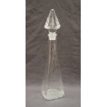 A Steven Newell glass decanter, with a pyramid shaped stopper and a tapering body on a square base,