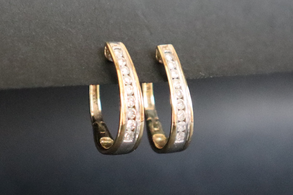 A pair of 14ct gold diamond set hoop earrings, with nine round brilliant cut diamonds, channel set, - Image 2 of 5