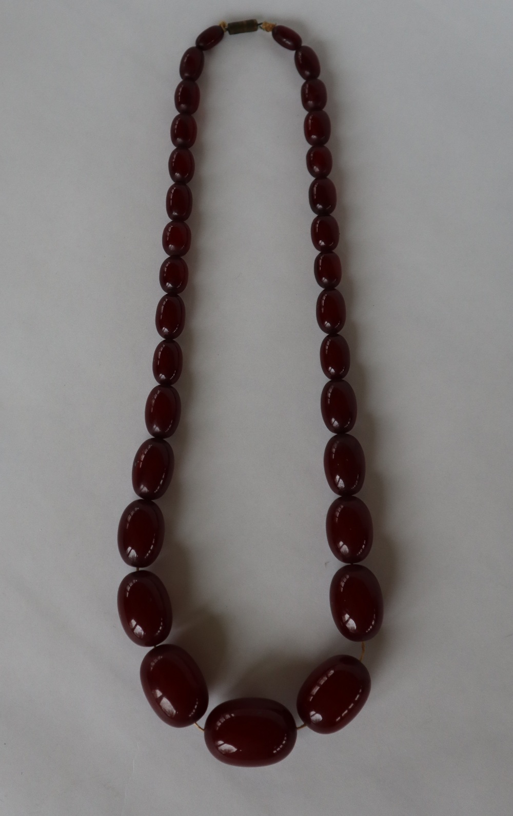 A string of cherry amber / bakelite beads, - Image 2 of 17