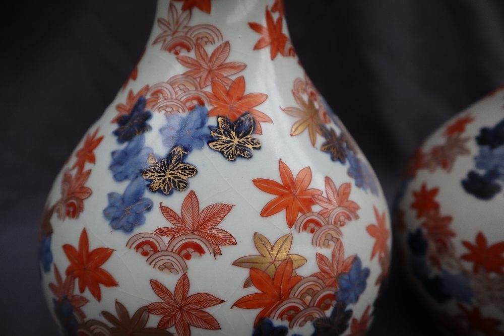 A pair of Japanese Imari pattern vases with a flared neck and tapering body, - Image 2 of 6