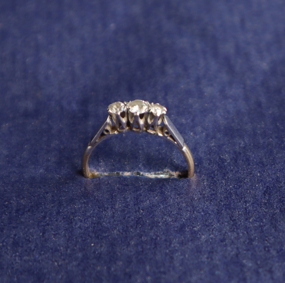 A three stone diamond ring set with round old cut diamonds of graduating sizes to a white metal - Image 2 of 4