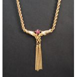 An 18ct yellow gold rope twist necklace, set with a ruby held between hands with tassels underneath,