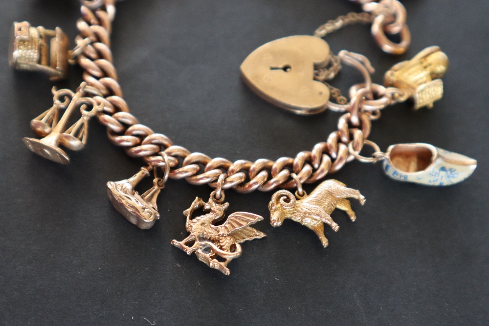 A 9ct yellow gold charm bracelet set with numerous charms including a St Christopher, Red Indian, - Image 3 of 6