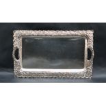 A silver twin handled tray of rectangular form, marks indistinct, 36.