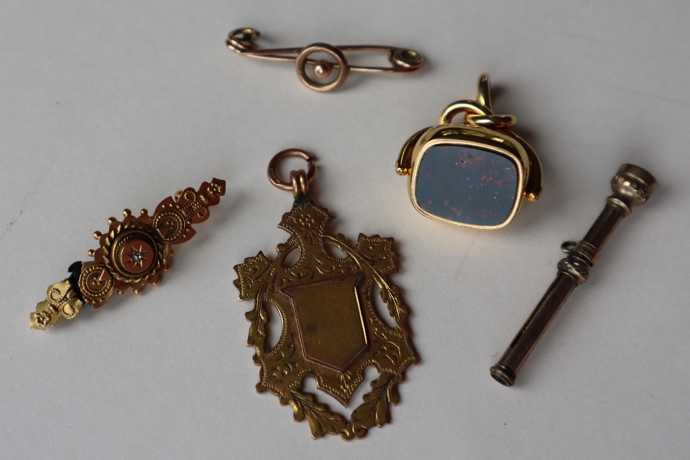 A 9ct gold shield medallion and a 9ct gold bar brooch approximately 7.