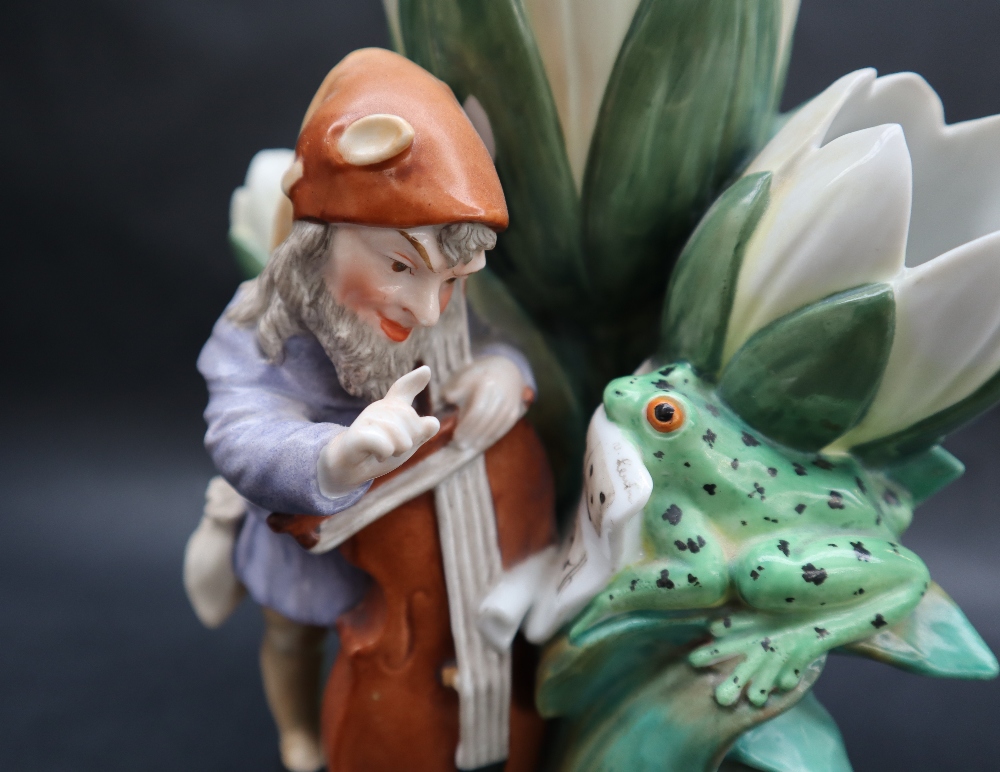 A continental porcelain triple lily vase moulded with a bearded sprite playing a cello with the - Image 2 of 9