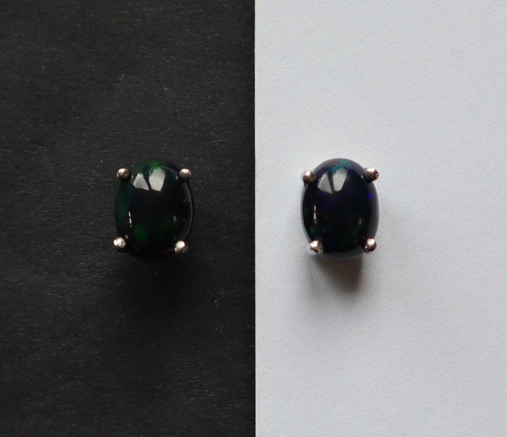 A pair of Ethiopian black opal stud earrings to a silver setting and post