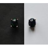 A pair of Ethiopian black opal stud earrings to a silver setting and post