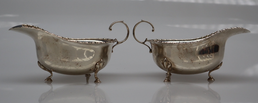 A pair of George V silver sauce boats with a reel rim on pad feet, Birmingham, 1911,