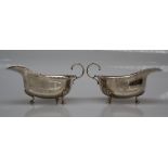 A pair of George V silver sauce boats with a reel rim on pad feet, Birmingham, 1911,