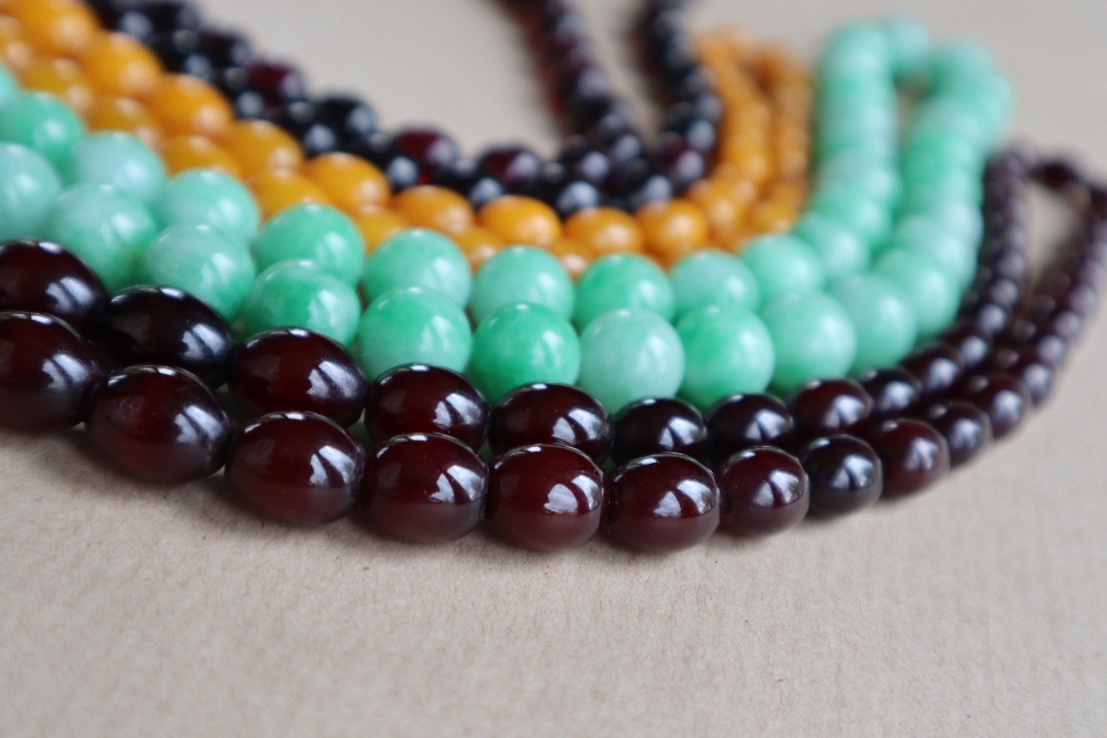 A Cherry amber / bakelite bead necklaces, with oval beads ranging in size from, 23mm to 8mm,