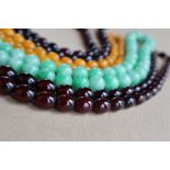 A Cherry amber / bakelite bead necklaces, with oval beads ranging in size from, 23mm to 8mm,