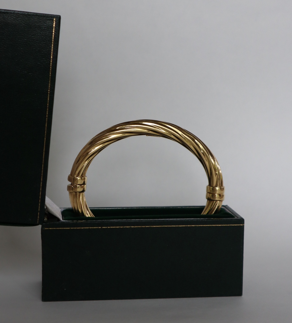 An 18ct yellow gold hinged bangle, of rope twist form,