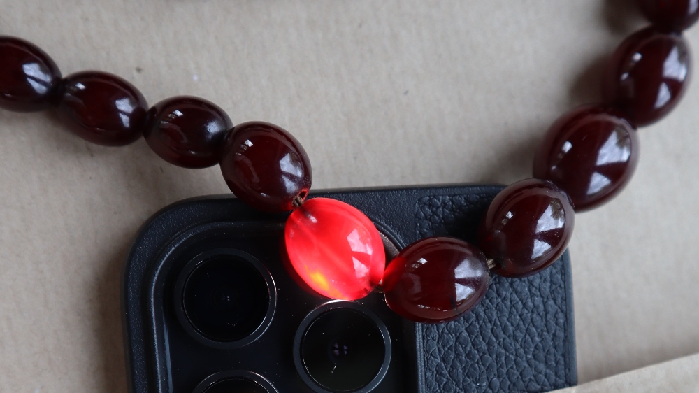 A Cherry amber / bakelite bead necklaces, with oval beads ranging in size from, 23mm to 8mm, - Image 8 of 14