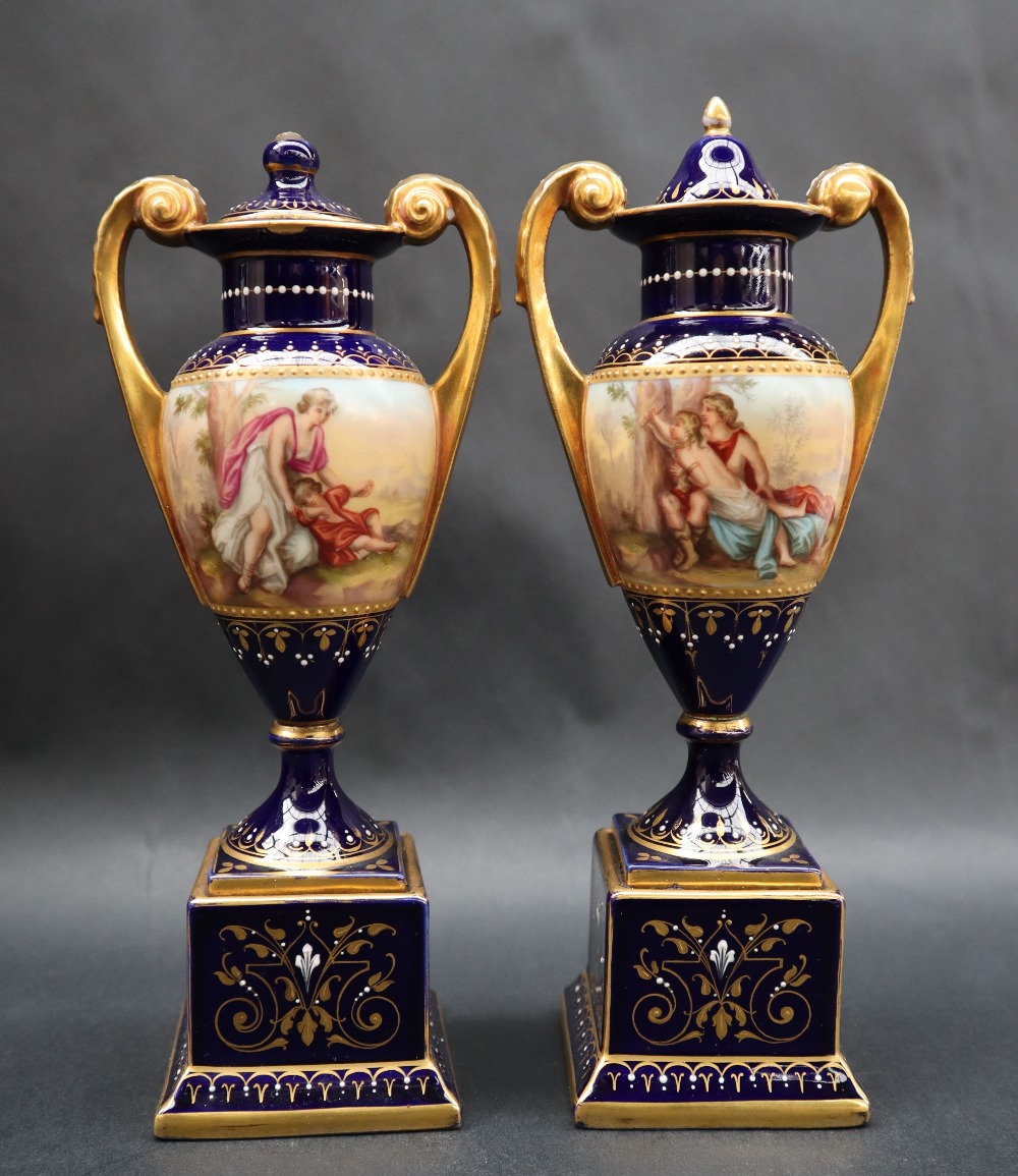 A pair of Vienna style twin handled vases and covers,