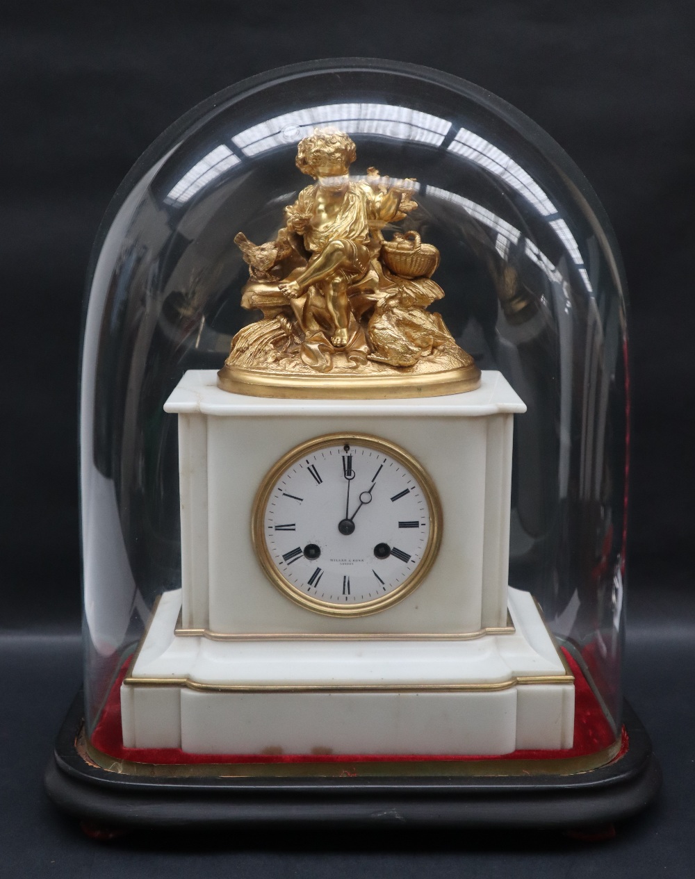 A 19th century white marble clock with a gilt metal surmount of a boy feeding chicken whilst seated