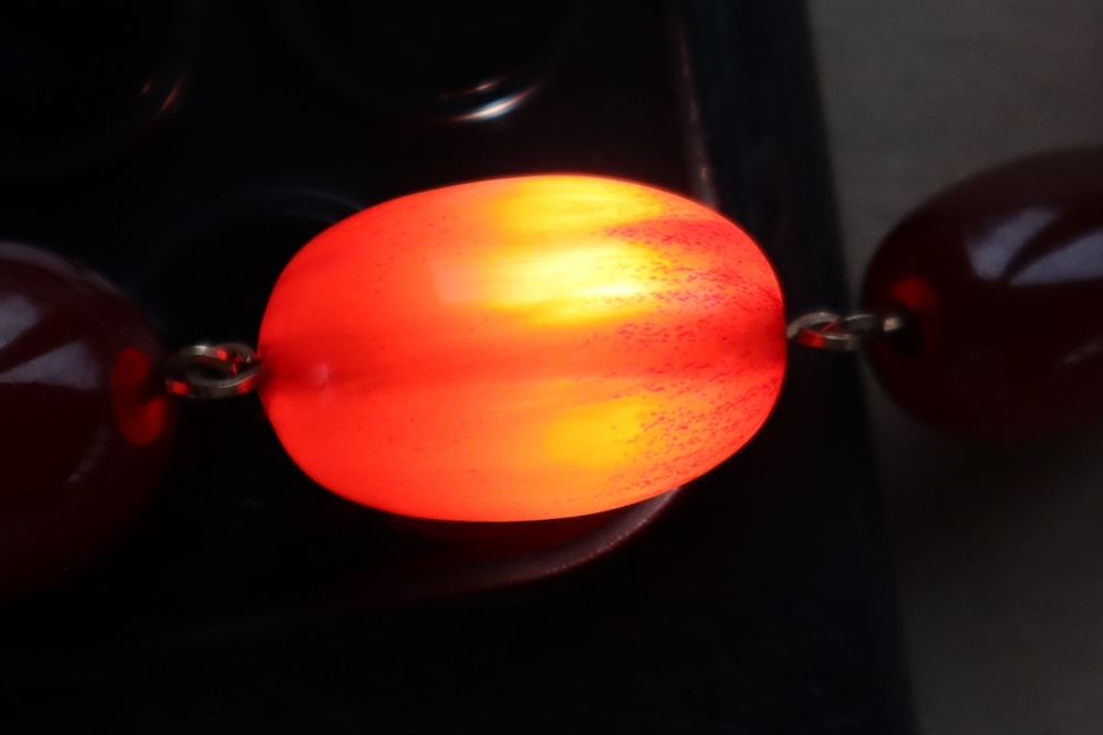 A string of cherry amber / bakelite beads, - Image 10 of 12