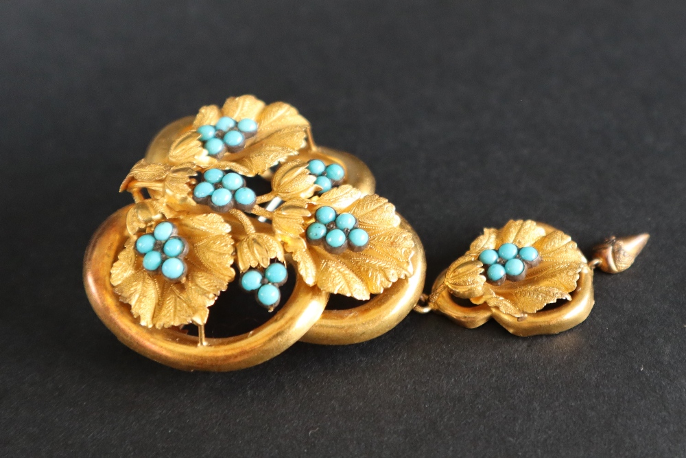 A Victorian yellow metal brooch in the form of three interlaced rings set with vine leaves and - Image 3 of 4