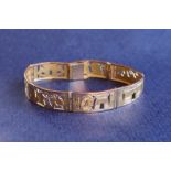 A yellow metal Egyptian bracelet, approximately 29 grams,