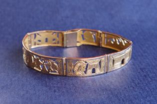 A yellow metal Egyptian bracelet, approximately 29 grams,