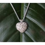 An 18ct white gold heart set with baguette and round brilliant cut diamonds 26mm wide,
