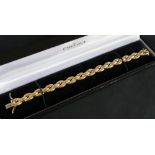 A 9ct yellow gold bracelet with interlaced oval links, 19cm long, approximately 16.