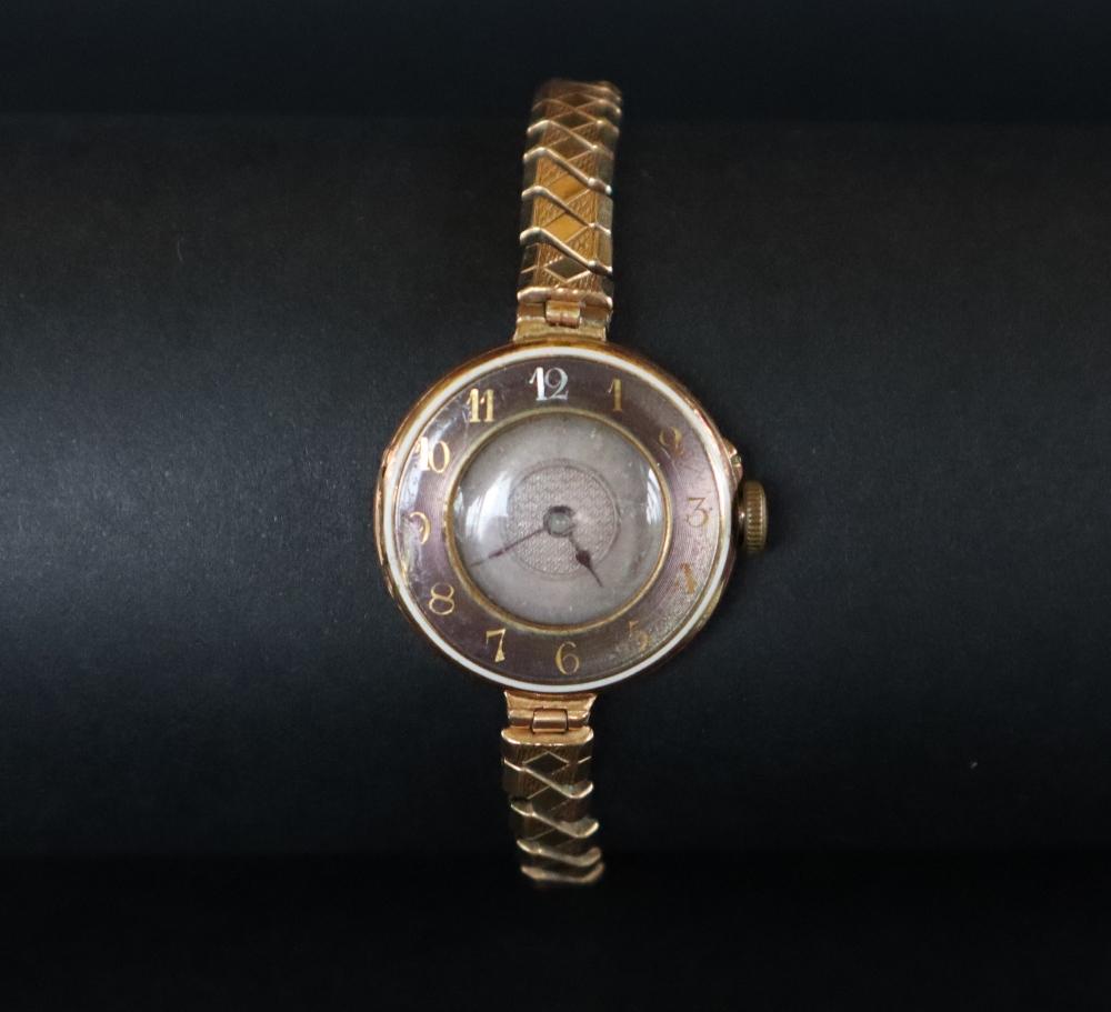 An 18ct gold lady's wristwatch the outer rim with Arabic numerals with a silvered dial,