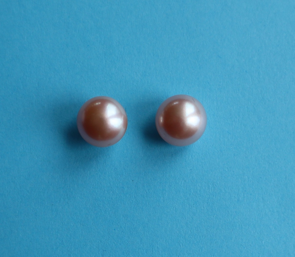 A pair of 9ct yellow gold studs set with oblate spheroid pink cultured pearls