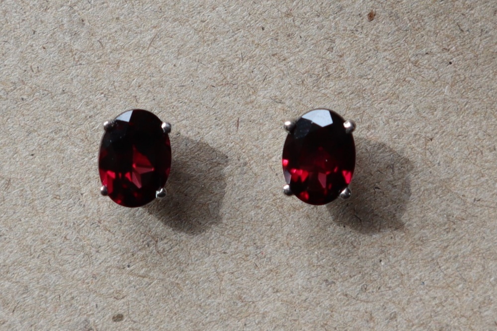 A pair of rhodolite garnet earrings to a silver setting and post