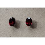 A pair of rhodolite garnet earrings to a silver setting and post