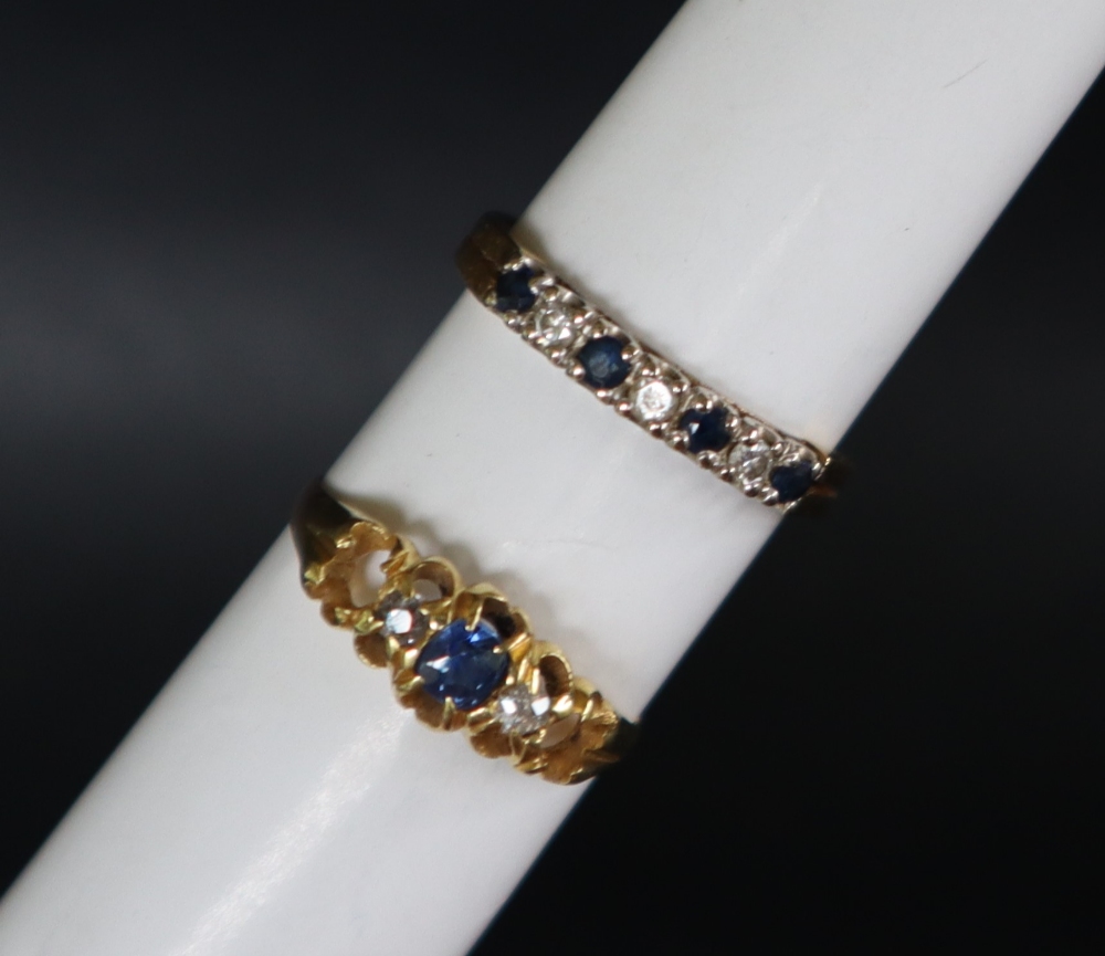 An 18ct yellow gold ring set with four round faceted sapphires and three round brilliant cut