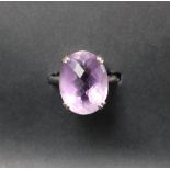 An amethyst dress ring, set with an oval cut amethyst, approximately 19mm x 14mm,