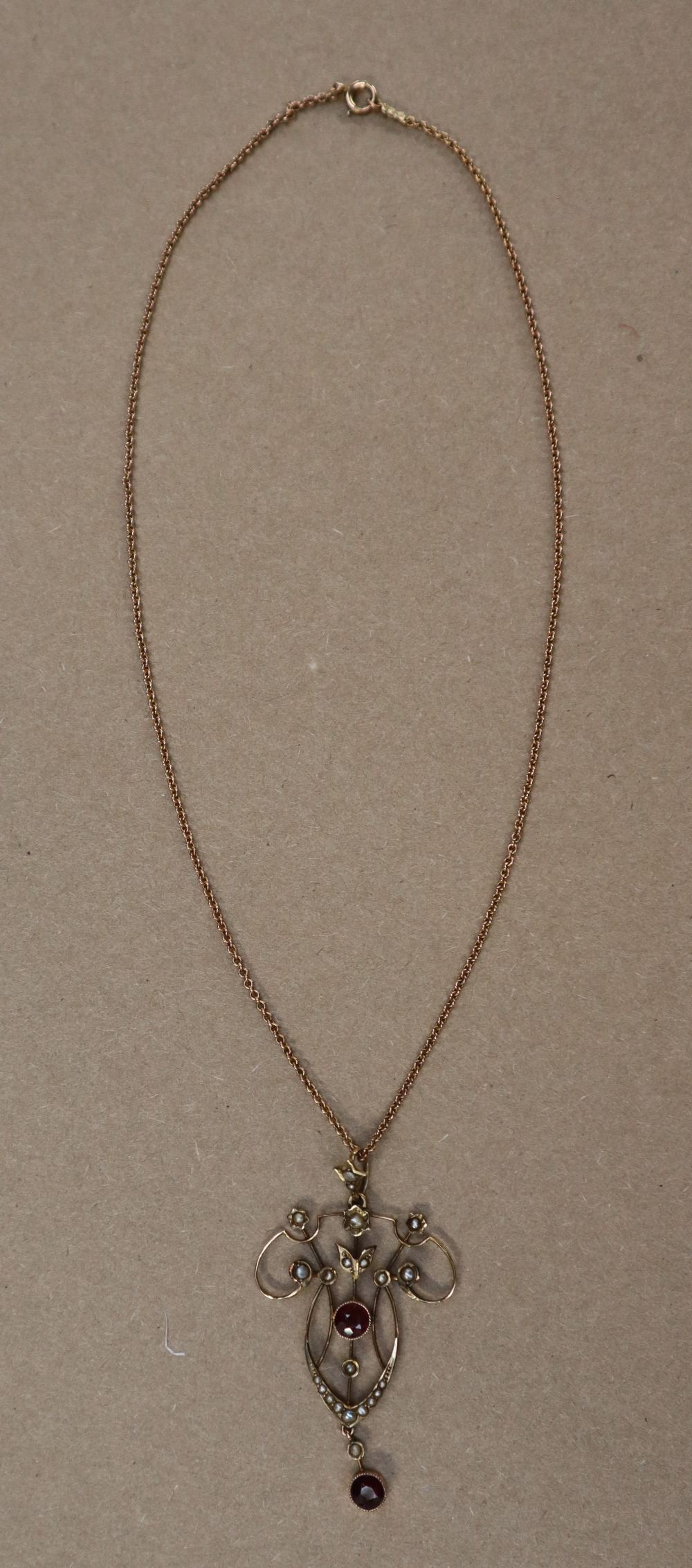 An Edwardian 9ct yellow gold garnet and seed pearl pendant on a 9ct gold chain, - Image 6 of 6