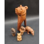 A Black Forest carved Bear lever nut cracker together with two carved bear topped bottle stops,