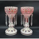 A pair of Victorian ruby and white flash glass table lustres painted with flowers and leaves, 29.
