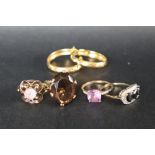 A 9ct yellow gold amethyst set dress ring together with two other 9ct gold rings another ring and