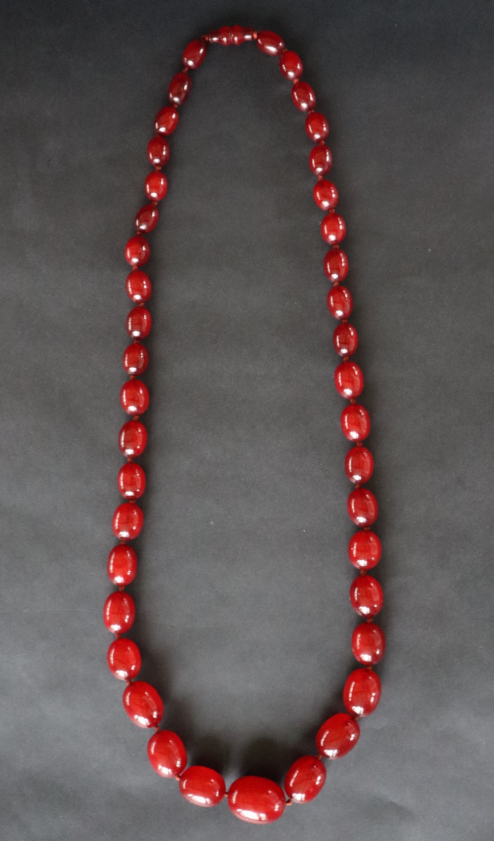 A string of cherry amber / bakelite beads,