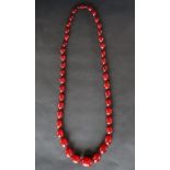 A string of cherry amber / bakelite beads,