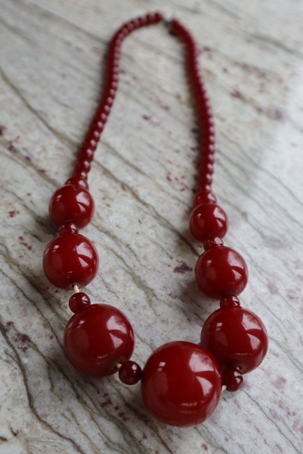 A string of cherry amber / bakelite beads, - Image 2 of 9