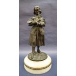 A bronze figure of Joan of Arc, with head bowed clutching a sword, on a circular marble base, 27.